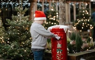 Child posting his Christmas wish list at Santas Grotto Galgorm